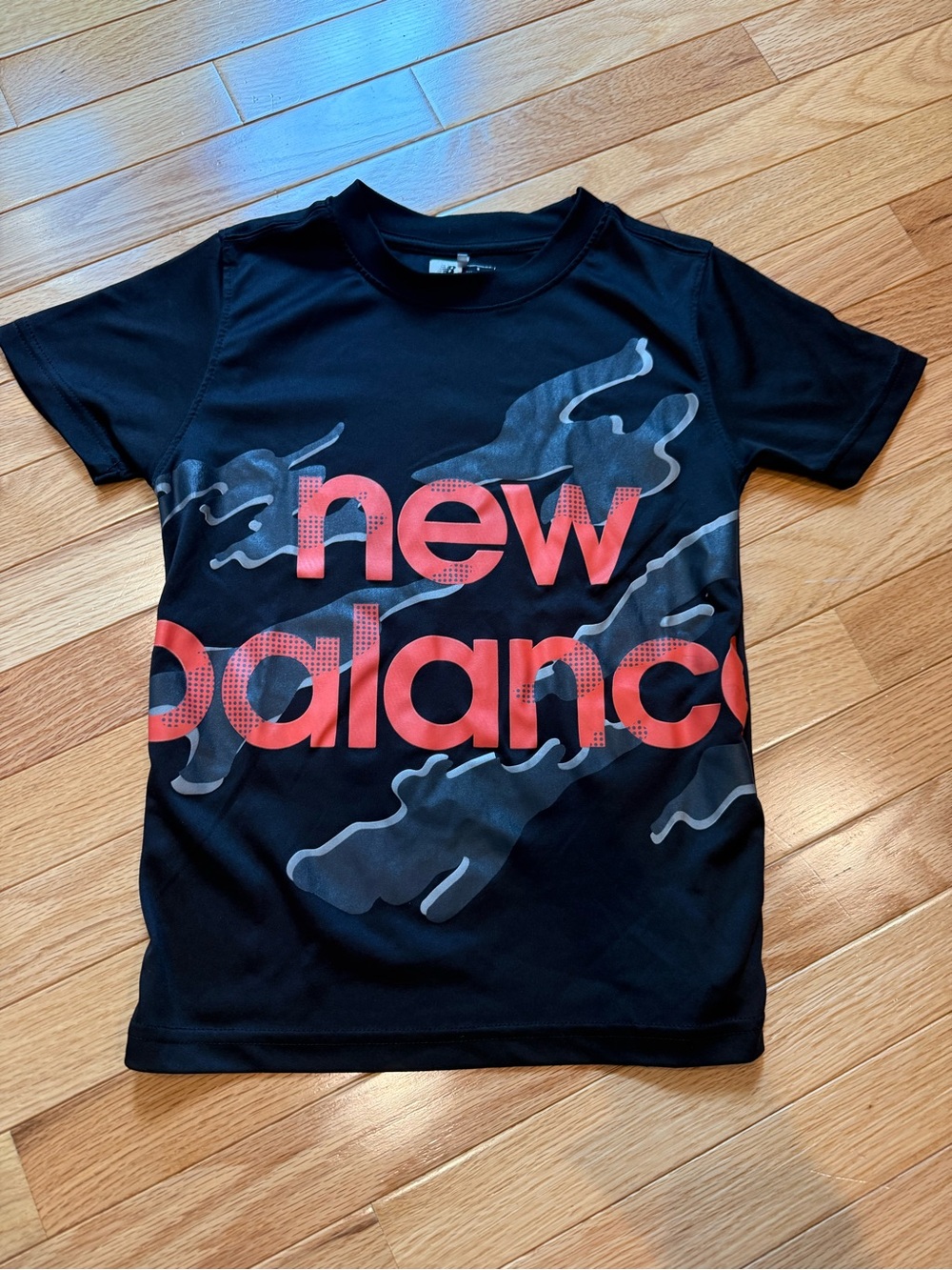 New Balance Black Tee with Orange Logo and Gray Camo Accents